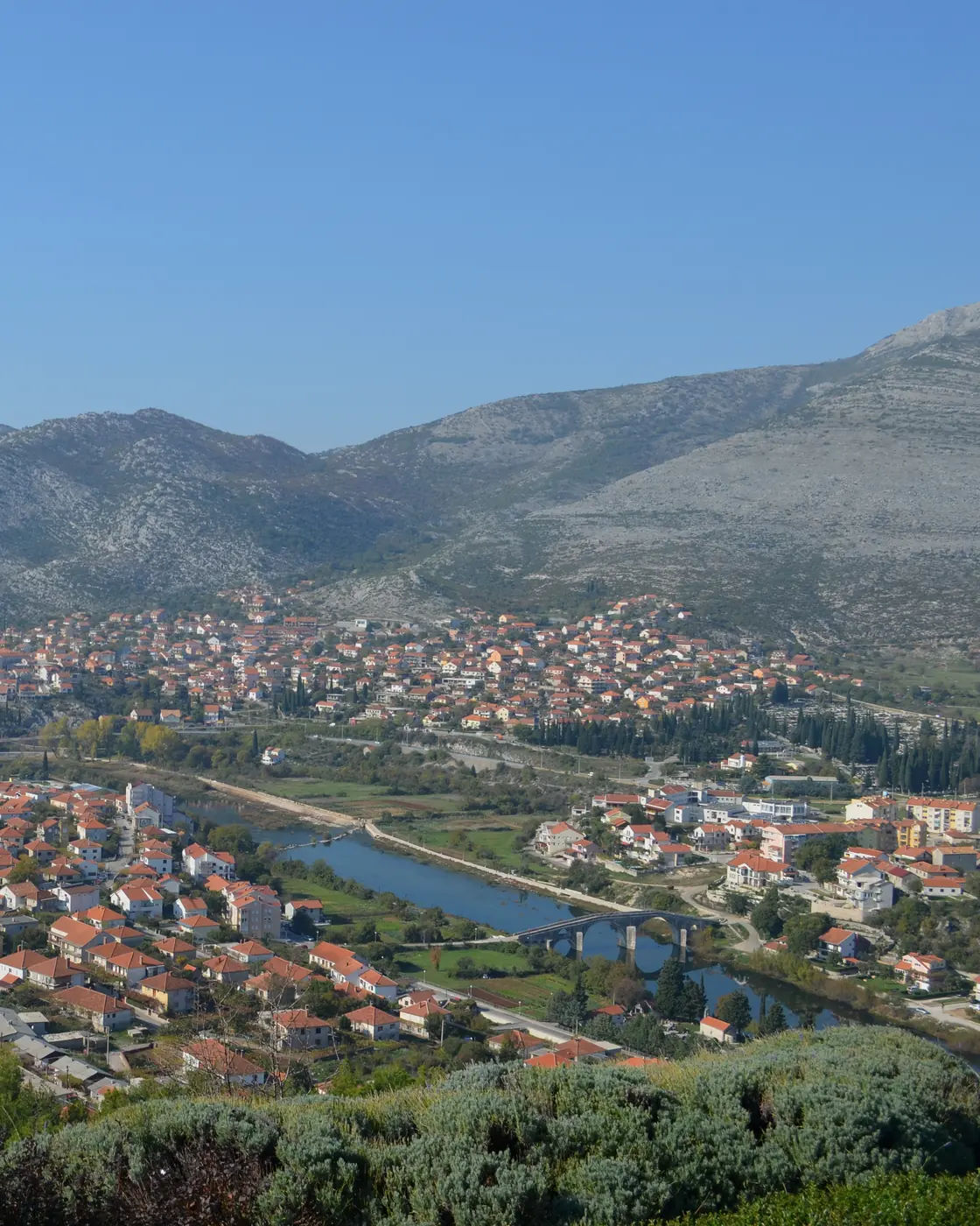 The old town of Trebinje from above, the Trebišnjica curving past it below the karst ridge